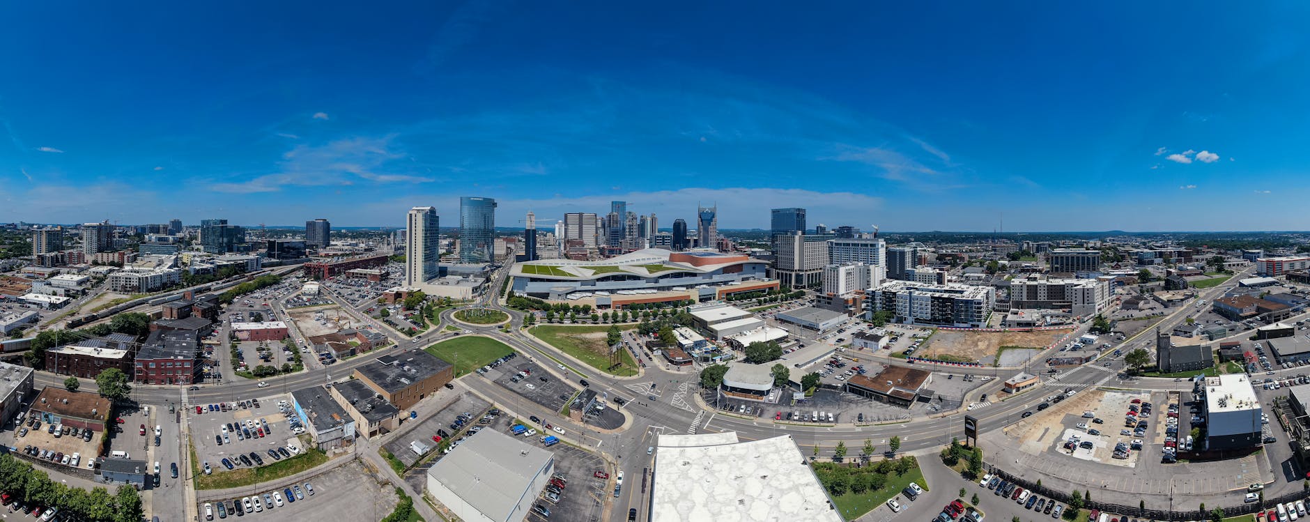 Drone view capturing the vibrant Nashville skyline with modern skyscrapers under a clear blue sky.