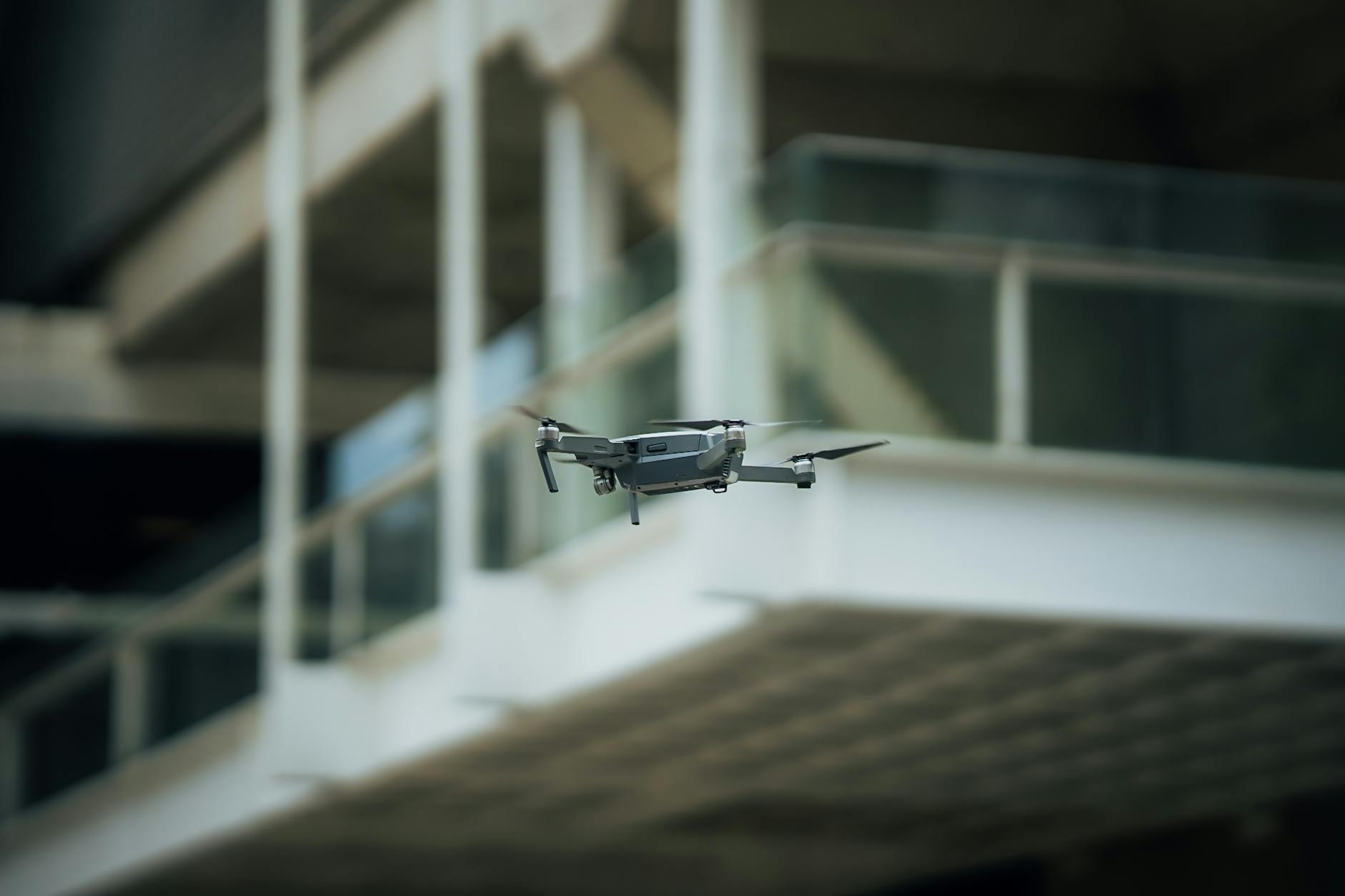 A sleek drone hovering inside an architectural setting, showcasing advanced technology.