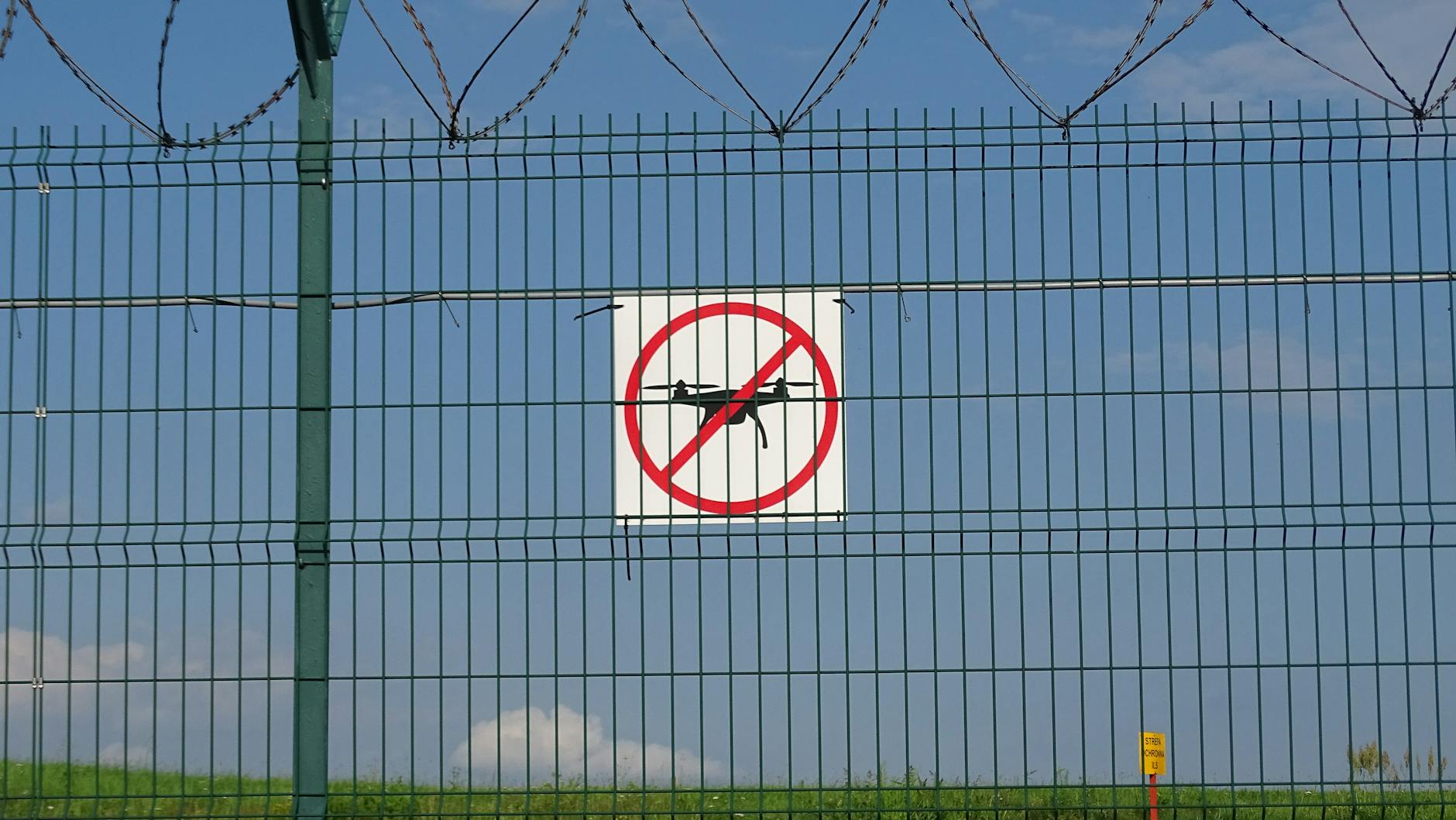 A 'No Drones' sign on a barbed wire fence in Morawica, Poland.