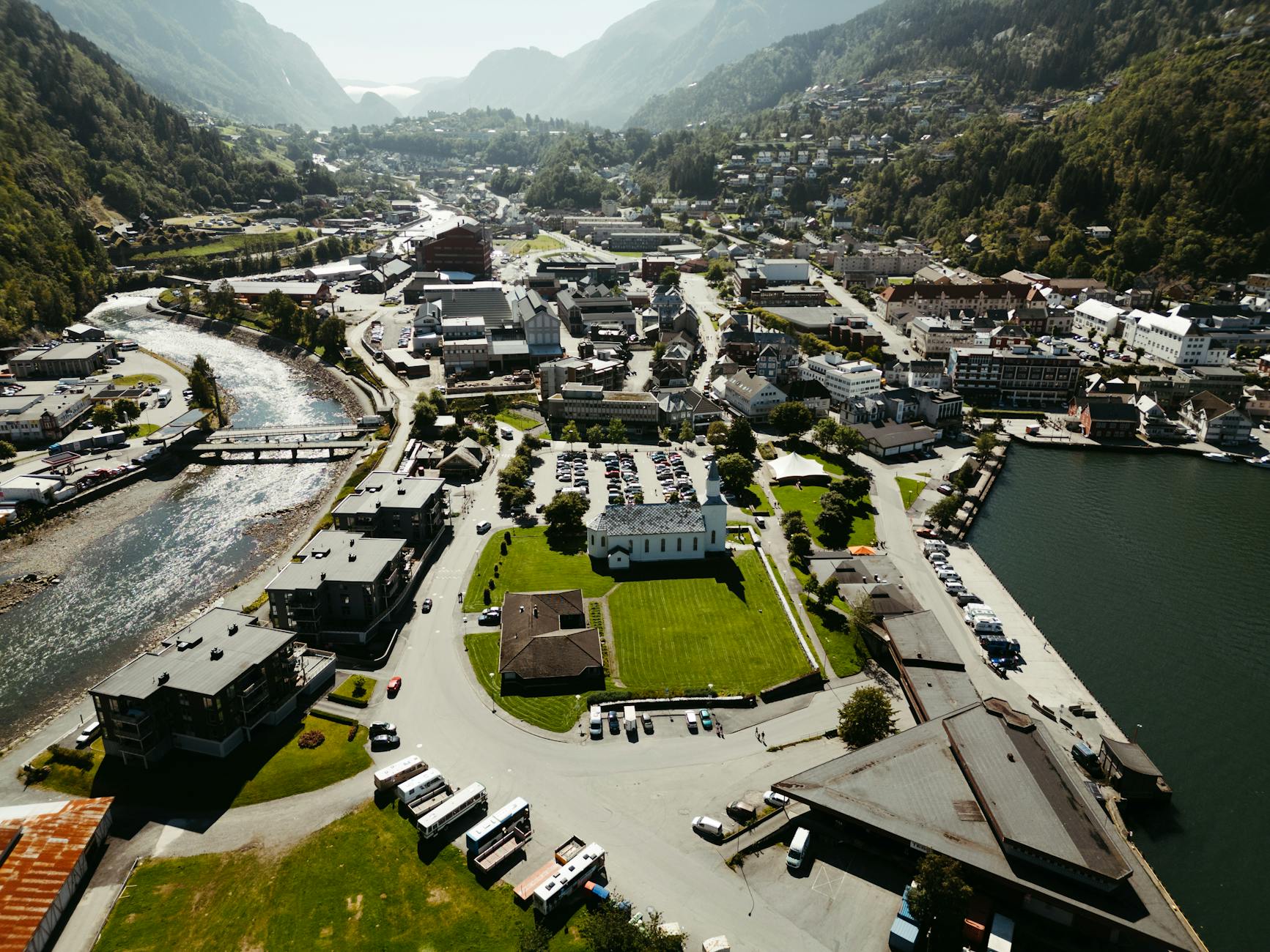 A stunning aerial view of Odda, nestled in the scenic Vestland region, Norway. Captures lush landscapes and urban details.